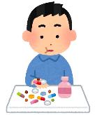 たくさんの薬を飲む男性